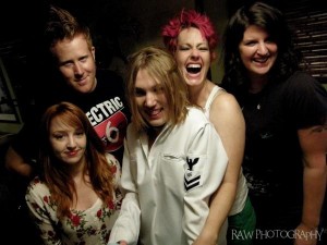 Photo courtesy of  DJ Rawburt of Raw Photograpy Red Fox (bass), Devin Tait (synth/vocals), AJ Anderson (guitar), Amy Crosby (lead vocals), and Laura Jennings (drums)